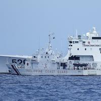 Chinese and Philippines military vessels in a contested area of the South China Sea