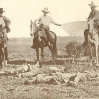The bodies of three Mexicans who were lynched in Texas being dragged to town by three Texas rangers, 1915.