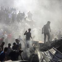 Palestinians search through rubble in Khan Younis after Israeli airstrikes, October 26, 2023.