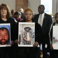 Three mothers hold pictures of their sons whose bodies were buried in unmarked graves without any notification.