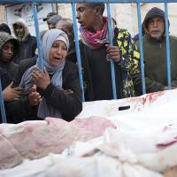 Palestinians at a hospital in Deir al Balah,l Gaza Strip, mourn the relatives killed in the Israeli air and ground offensive, January 26, 2024.