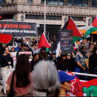 The Revcom Corps banner in the midst of thousands in Los Angeles who came into the streets on a rainy day to protest genocide in Palestine, March 2, 2024.