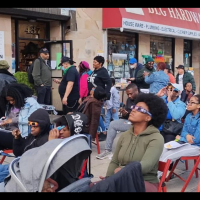 People outside Revolution Books NYC watching the eclipse: “The Eclipse Party at the Bookstore that Has the Whole World in Mind.”