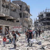 Palestinians walk through destruction after Israeli bombing of the Jabalya refugee camp in Gaza, May 30, 2024.