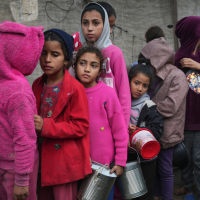 Palestinian children queue for food at a center in Deir al-Balah, Gaza Strip, November 28, 2024.