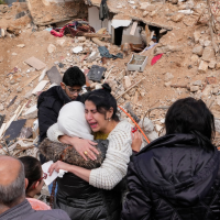 Grieving in front of their destroyed house in Baalbek, eastern Lebanon, November 28, 2024