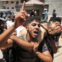 Palestinians wounded and killed while trying to reach aid trucks are brought to Shifa Hospital in Gaza City, July 20, 2025.