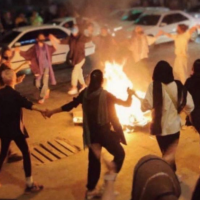 Women dance around a bonfire of burning headscarves, Bandar Abbas, Iran, September 22, 2022.