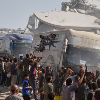 Freed Palestinian prisoners are greeted as their buses pass the rubble in Khan Younis, October 13, 2025.
