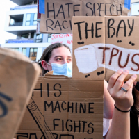 Protesters with signs stand outside a Turning Point USA event at the University of California, Berkeley, November 10, 2025