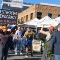“Signs of Fascism” at the Hollywood Farmers Market, Los Angeles, November 28, 2025.