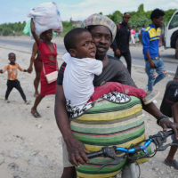 Haitians flee their homes to escape clashes between armed gangs in Port-au-Prince, Haiti, May 11, 2026.