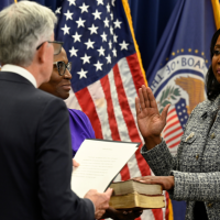 Lisa Cook being sworn in as a member of the Federal Reserve Board of Governors by Jerome Powell, May 2022.